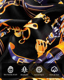 A close-up of a silk scarf with golden chains pattern and various symbols highlighting the characteristics and details of its material.