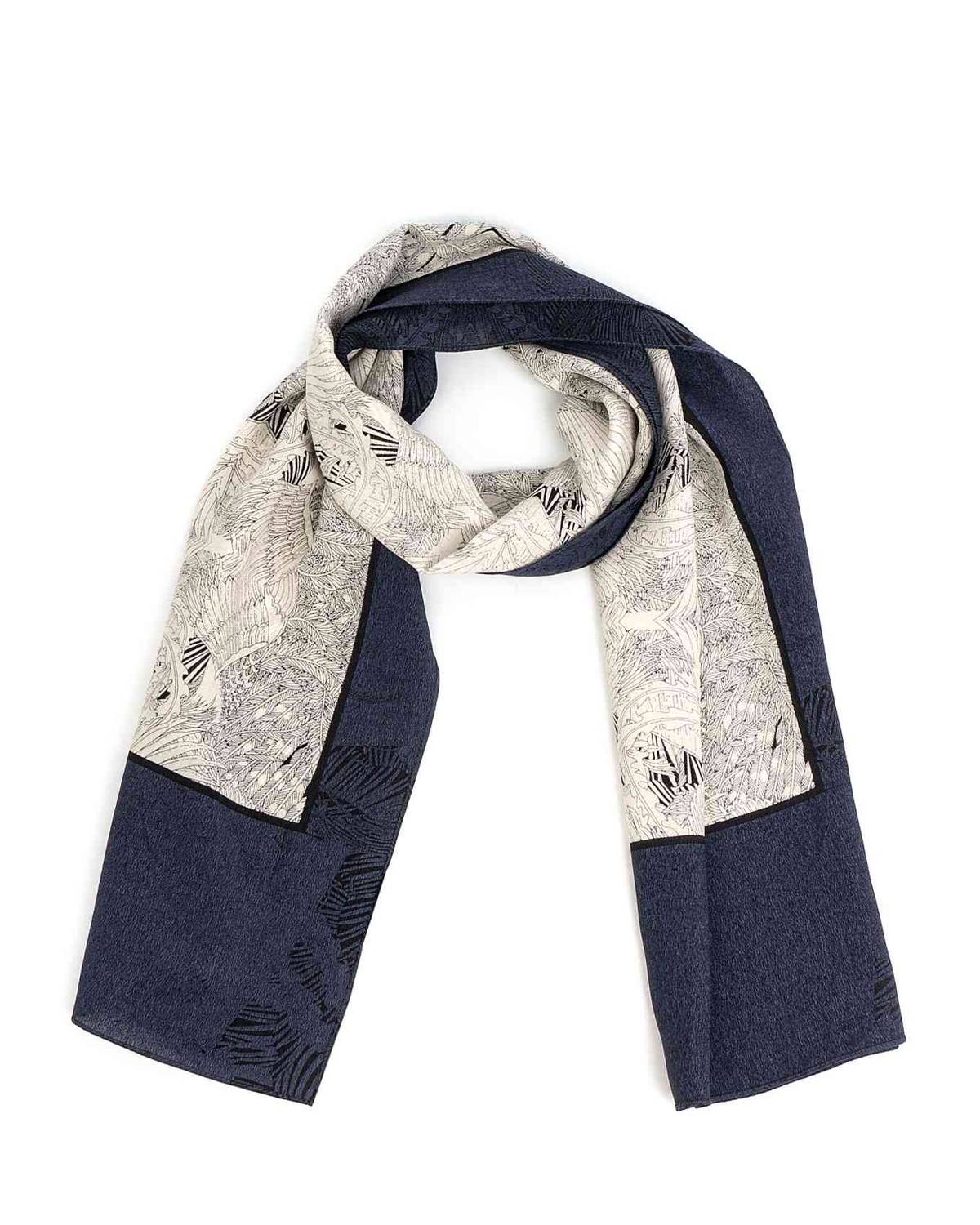 A rectangular silk scarf featuring a detailed map design, elegantly draped to showcase its intricate patterns.