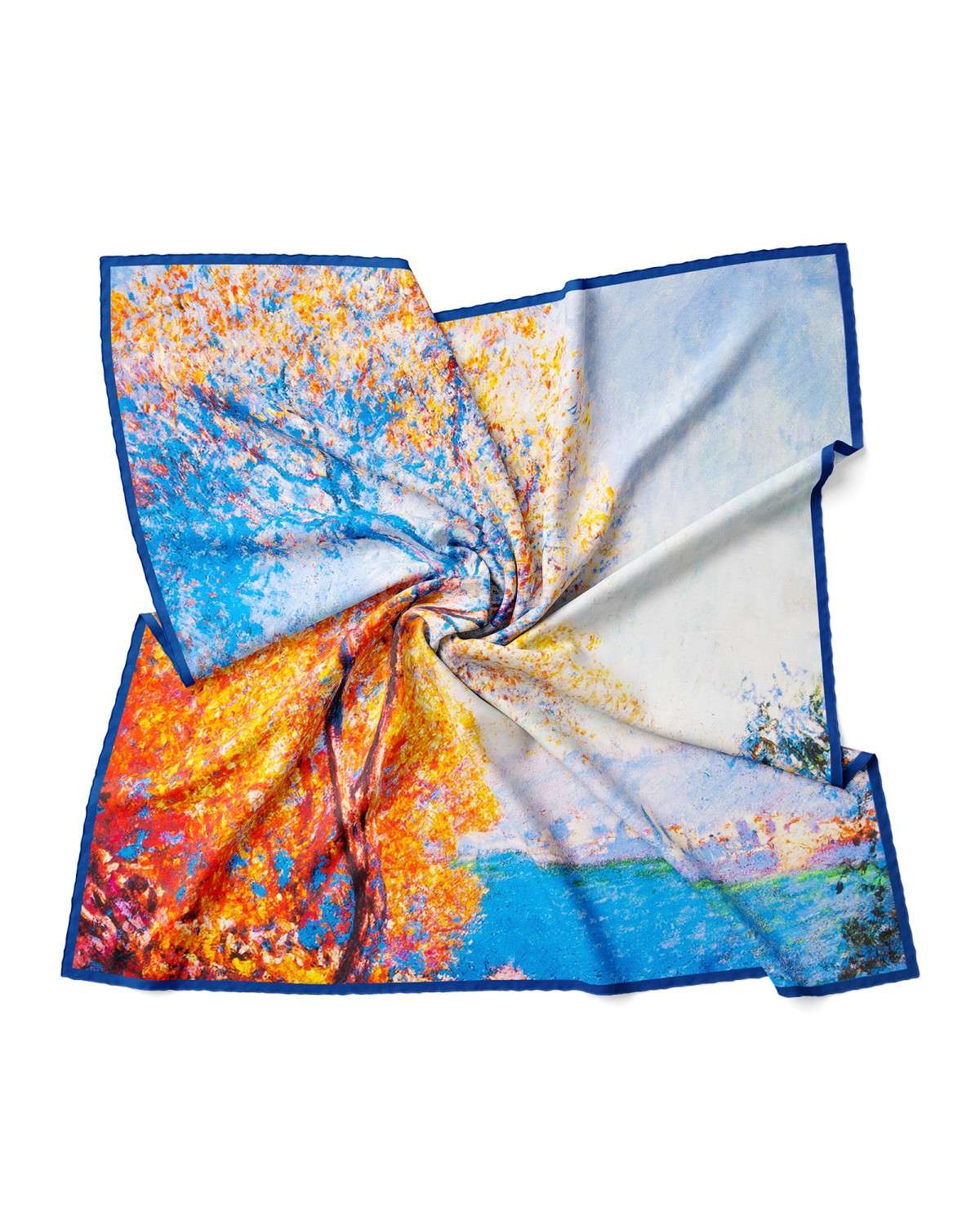 A silk scarf featuring a vibrant tree design against a clear blue sky background.