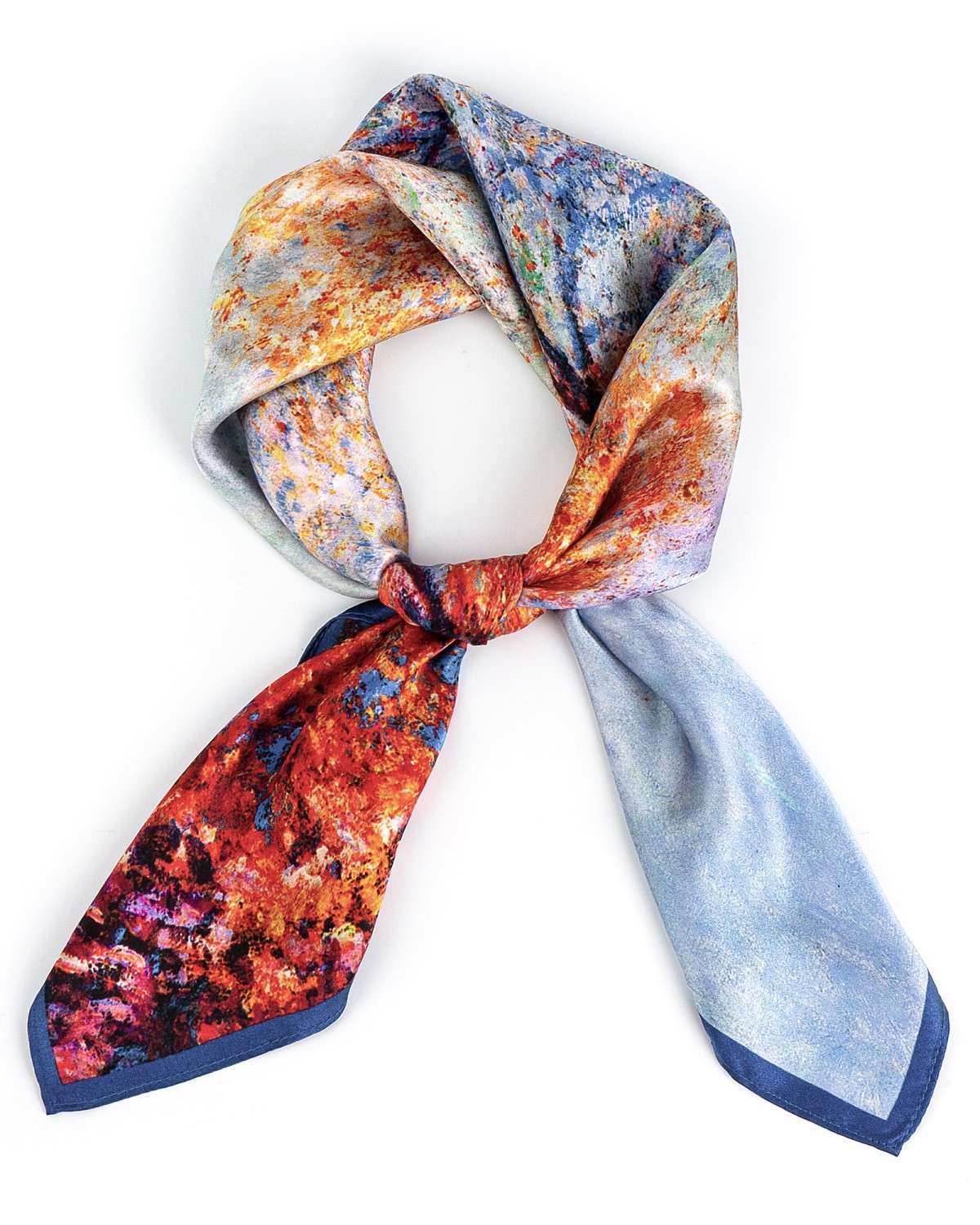 A knotted silk scarf featuring a vibrant, colorful design, elegantly displayed against a neutral background.